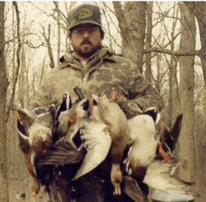 Kirk McCullough back in the early days of using his Cut down Olt duck call. Holding the duck kills of the day from hunting green timber duck hunting on the flooded public lands of Bayou Meto, Arkansas.