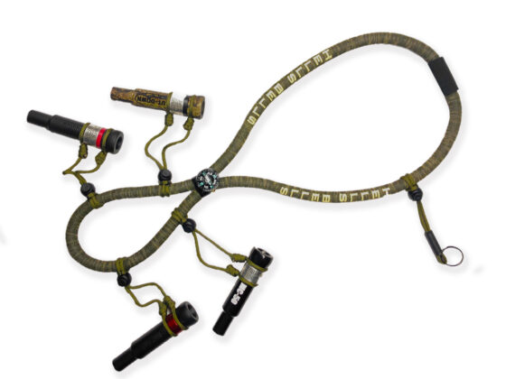 Hells Bells Camo Lanyard with Screen Print - Floating Duck Call Lanyard with Compass This lanyard combines rugged Hells Bells camo with screen printing for added style. Choose with or without a compass. A floating duck call lanyard that keeps your calls afloat if dropped in water. The built-in compass aids navigation, ensuring you find the ideal hunting spot and your way back home. (Note: Duck calls not included)